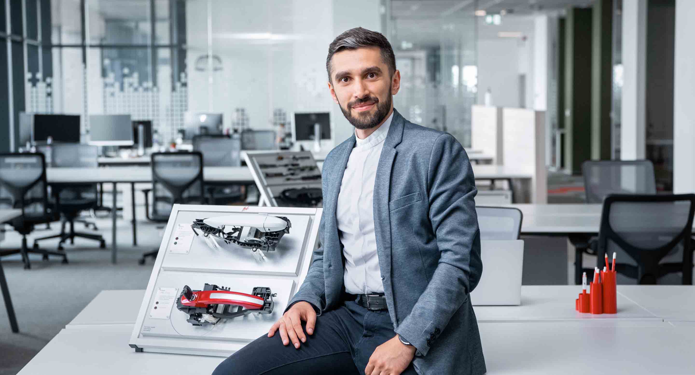 Huf manager sitting in open space office representing modern working situation