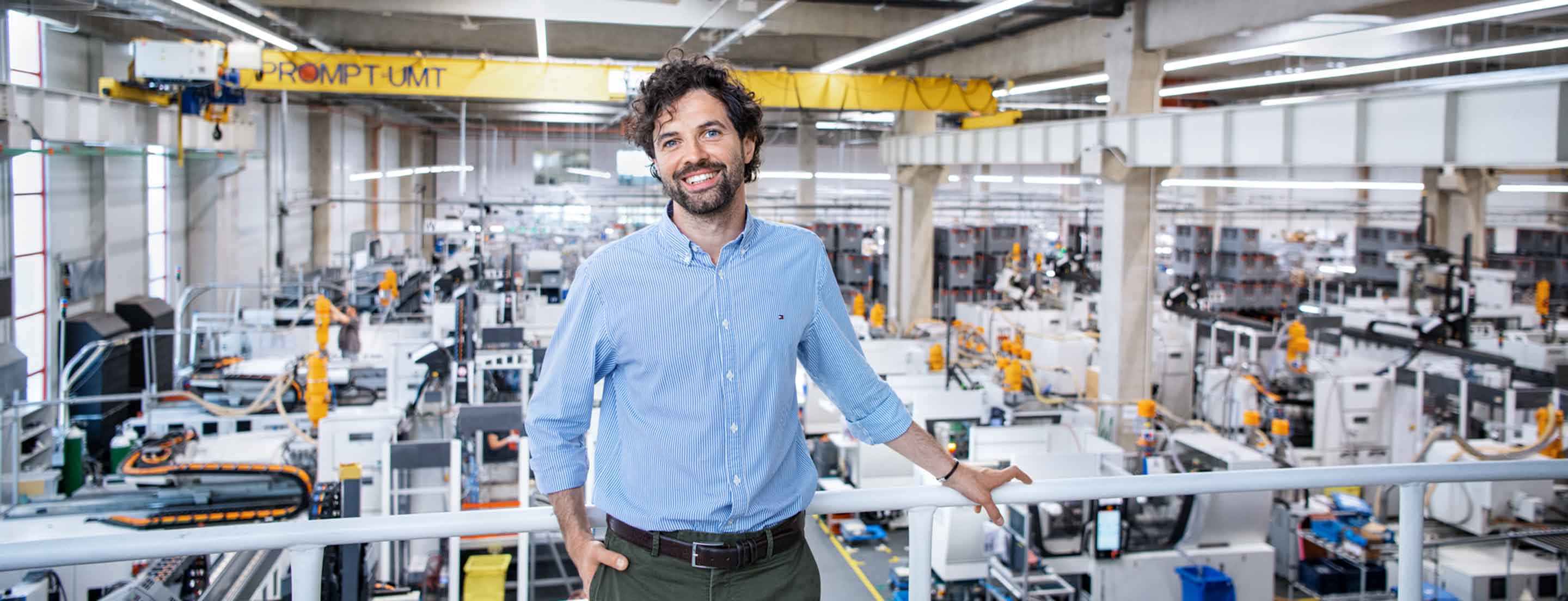 Huf employee standing in front of Huf production hall